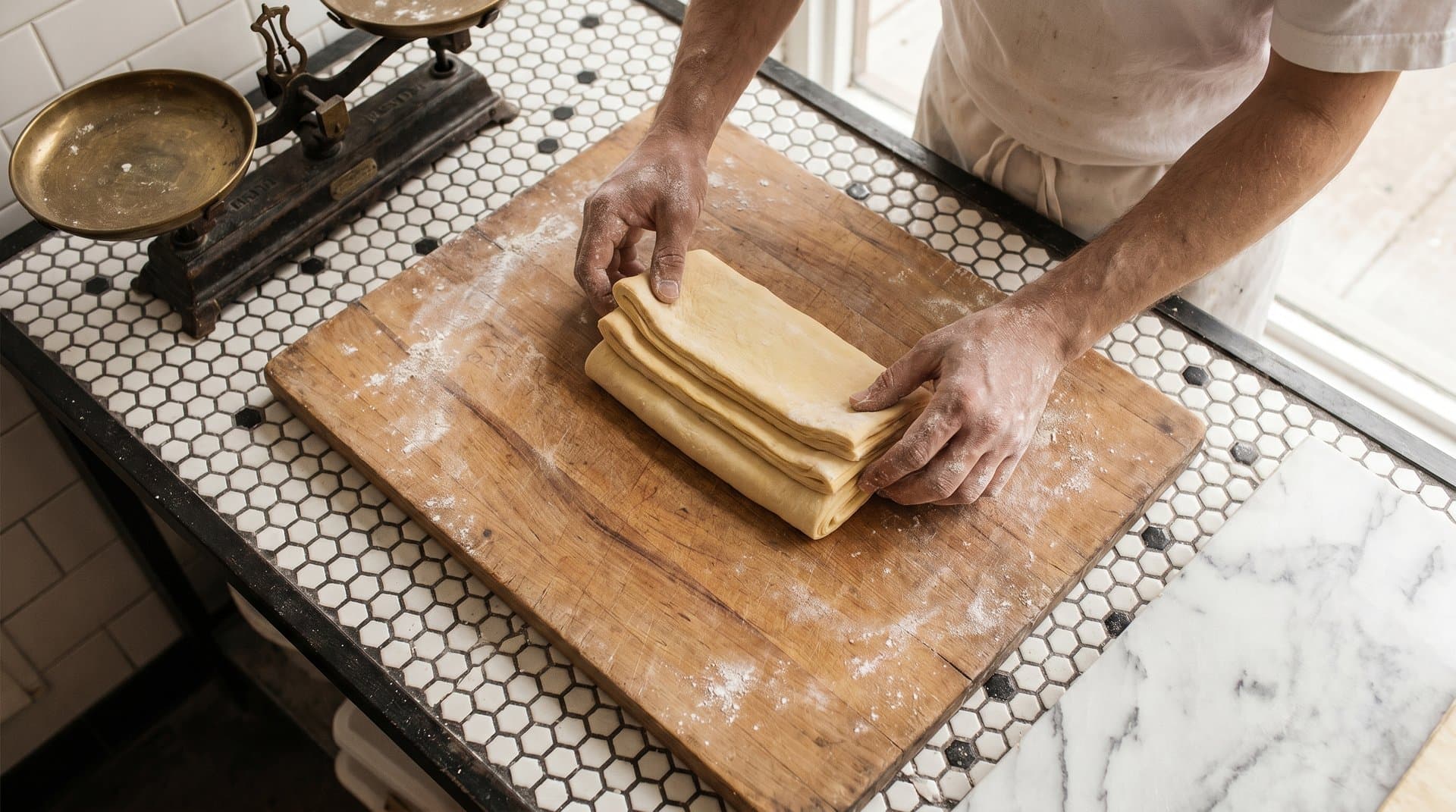 Crosodo team — hands working laminated dough